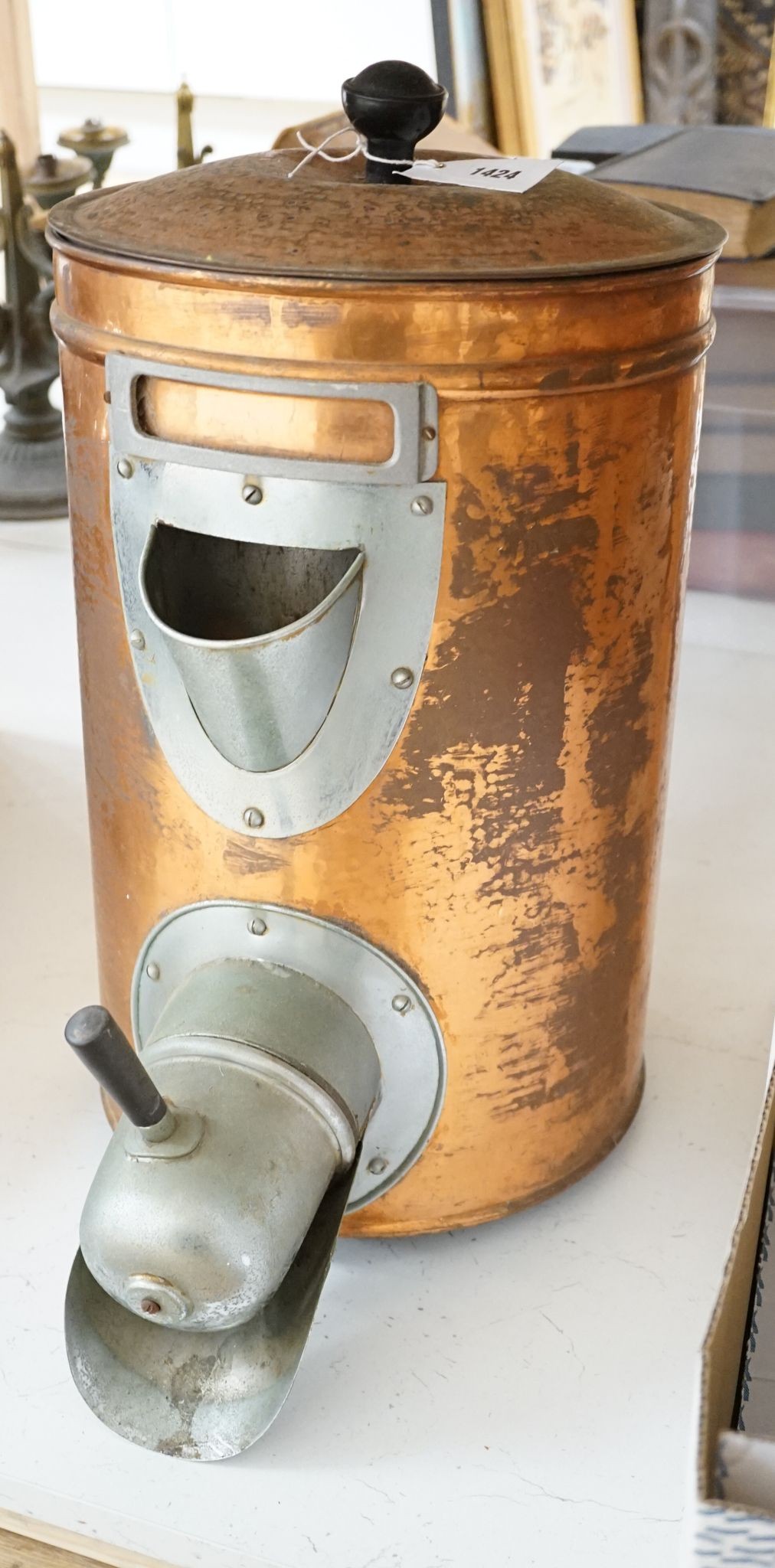 A copper coffee bean dispenser, 60 cms high.